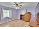 Bedroom with hardwood floors, ceiling fan, and built-in shelving at 5401 Peeples Rd, Plant City, FL 33565