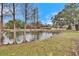 Pond view with cypress trees and home in background at 5401 Peeples Rd, Plant City, FL 33565