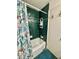 Clean bathroom with shower/tub combo, vanity, and green tile at 10937 N Lantana Ave, Tampa, FL 33612