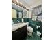 Bathroom features a vanity, toilet, and green tile at 10937 N Lantana Ave, Tampa, FL 33612