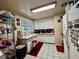 White kitchen cabinets, stainless steel appliances, and a red floor at 10937 N Lantana Ave, Tampa, FL 33612