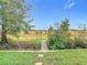 View of backyard with wooden footbridge and open field at 11701 Brighton Knoll Loop, Riverview, FL 33579