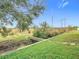 Landscaped backyard with a wooden footbridge at 11701 Brighton Knoll Loop, Riverview, FL 33579