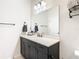 Bathroom with dark vanity, quartz countertop, and a large mirror at 11701 Brighton Knoll Loop, Riverview, FL 33579