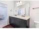 Double vanity bathroom with dark brown cabinets and a large mirror at 11701 Brighton Knoll Loop, Riverview, FL 33579