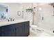 Modern bathroom with dark vanity, a frameless shower, and white tile at 11701 Brighton Knoll Loop, Riverview, FL 33579