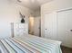 Bedroom with a striped comforter and white dresser, showing access to other rooms at 11701 Brighton Knoll Loop, Riverview, FL 33579