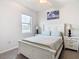 Bright bedroom with a striped comforter and white wooden frame bed at 11701 Brighton Knoll Loop, Riverview, FL 33579