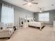 Main bedroom with a ceiling fan, gray walls, and plush carpet at 11701 Brighton Knoll Loop, Riverview, FL 33579