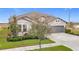 Two-story house with gray siding, stone accents, and a three-car garage at 11701 Brighton Knoll Loop, Riverview, FL 33579