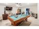 Game room with pool table, seating, and adjacent living space at 11701 Brighton Knoll Loop, Riverview, FL 33579