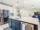 Modern kitchen island with white quartz countertop, stainless steel appliances, and a farmhouse sink at 11701 Brighton Knoll Loop, Riverview, FL 33579