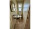 Small bathroom with single sink, toilet, and tiled floor at 122 Gulf Breeze Blvd, Venice, FL 34293