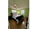 Cozy bedroom with a full-size bed and light green walls at 122 Gulf Breeze Blvd, Venice, FL 34293