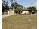 House with a spacious lawn and a two-car garage at 122 Gulf Breeze Blvd, Venice, FL 34293