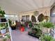 Screened patio with seating area and lush potted plants at 122 Gulf Breeze Blvd, Venice, FL 34293