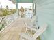 Spacious balcony with white chairs and view of neighborhood at 130 Bay Plz, Treasure Island, FL 33706