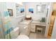 Bathroom with white vanity, marble countertop, and a toilet at 130 Bay Plz, Treasure Island, FL 33706