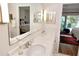 Double vanity bathroom with a large mirror and view into bedroom at 130 Bay Plz, Treasure Island, FL 33706