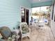 Relaxing screened porch with wicker furniture and tile floor at 130 Bay Plz, Treasure Island, FL 33706