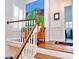 Stunning staircase with wooden railing and large artwork at 130 Bay Plz, Treasure Island, FL 33706