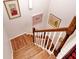 Bright staircase with wood steps, white risers and balusters, and artwork on the wall at 130 Bay Plz, Treasure Island, FL 33706