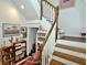 Charming staircase with wood treads, white risers, and decorative display shelving at 130 Bay Plz, Treasure Island, FL 33706