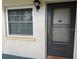 Condo unit entrance with screen door at 1415 Doolittle Ln # 107, Dunedin, FL 34698