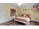 Bedroom with queen bed, hanging chair, and wood floors at 3011 39Th E St, Bradenton, FL 34208