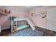 Pink bedroom with bunk bed, slide, and dresser at 3011 39Th E St, Bradenton, FL 34208