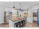 Modern kitchen with large island, stainless steel appliances, and blue pantry door at 3011 39Th E St, Bradenton, FL 34208