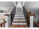 Stunning wooden staircase with black metal railings at 3011 39Th E St, Bradenton, FL 34208