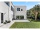 Contemporary home with large backyard, patio, and grassy area at 3110 W Napoleon Ave, Tampa, FL 33611