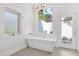 Modern bathroom with freestanding tub and large window at 3110 W Napoleon Ave, Tampa, FL 33611