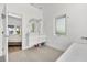 Modern bathroom with double vanity, soaking tub, and a view into bedroom at 3110 W Napoleon Ave, Tampa, FL 33611