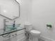 Modern powder room with glass sink and geometric tile floor at 3110 W Napoleon Ave, Tampa, FL 33611