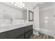 Modern bathroom with double sinks, bathtub and gray cabinets at 3110 W Napoleon Ave, Tampa, FL 33611