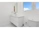 Bright bathroom featuring a floating vanity and large window at 3110 W Napoleon Ave, Tampa, FL 33611