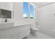 Clean bathroom with a white vanity, toilet and bathtub at 3110 W Napoleon Ave, Tampa, FL 33611