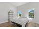 Spacious bedroom with a queen bed and two windows at 3110 W Napoleon Ave, Tampa, FL 33611