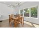 Bright dining area with hardwood floors and large windows overlooking backyard at 3110 W Napoleon Ave, Tampa, FL 33611