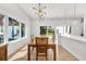 Modern dining room with large windows and a mid-century modern dining set at 3110 W Napoleon Ave, Tampa, FL 33611