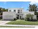 Contemporary two-story home with attached garage and neat landscaping at 3110 W Napoleon Ave, Tampa, FL 33611