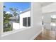 Light-filled hallway with wood floors and a view from a large window at 3110 W Napoleon Ave, Tampa, FL 33611