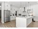 Modern kitchen featuring white cabinetry, stainless steel appliances, and a large island at 3110 W Napoleon Ave, Tampa, FL 33611