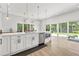 Bright kitchen with white cabinets, stainless steel appliances, and sliding glass doors to backyard at 3110 W Napoleon Ave, Tampa, FL 33611