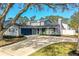 Two-story house with gray siding, blue door, and a spacious driveway at 4101 Dellbrook Dr, Tampa, FL 33624