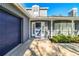 Gray brick house with a blue door, wreath, and attached garage at 4101 Dellbrook Dr, Tampa, FL 33624