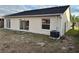 Tan house exterior with sliding glass doors leading to a backyard patio at 4710 Bloom Dr, Plant City, FL 33566