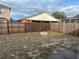 Backyard with wooden fence and fire pit at 4710 Bloom Dr, Plant City, FL 33566